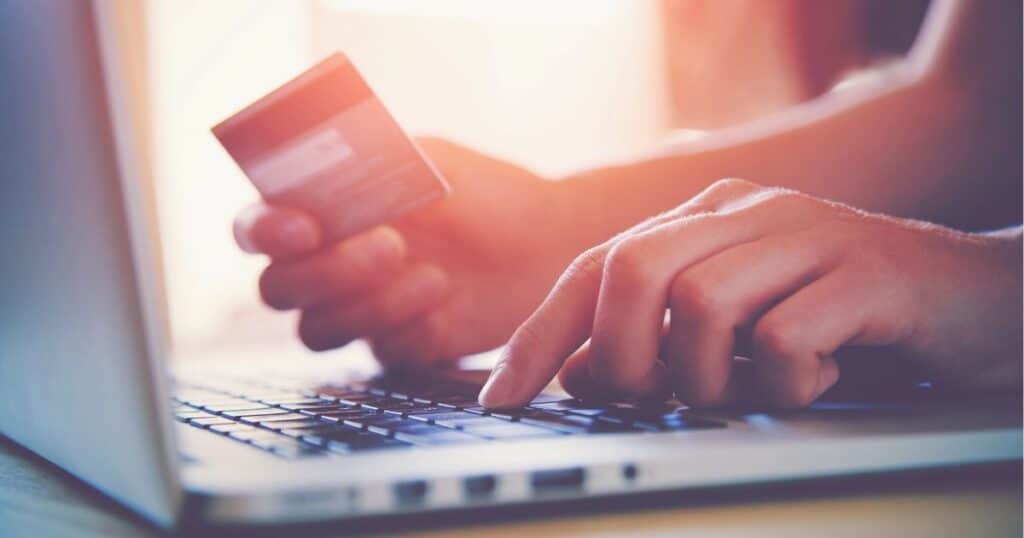 woman with credit card on lap top