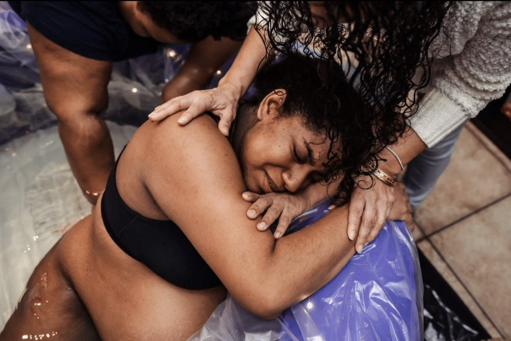Laboring parent during contraction in birth tub. Photo by Danielle Wilstead of Wild Oak Photography in Salt Lake City.
