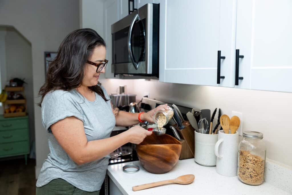Salt Lake City Doula Beth Hardy preparing postpartum energy balls for a new family in their home