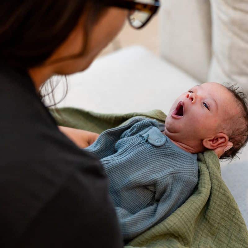 Salt Lake City doula Beth Hardy holding yawning tired baby
