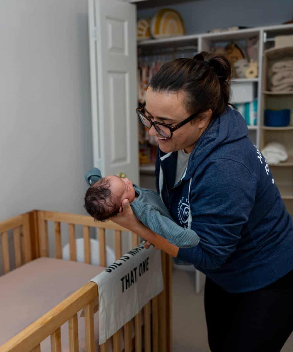 baby sleep coach with infant and crib