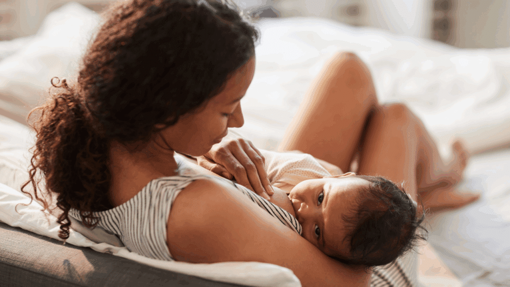 Breastfeeding parent in bed