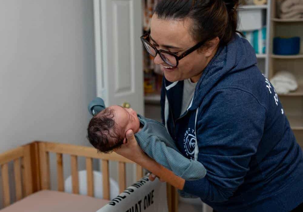 baby sleep coach with infant and crib